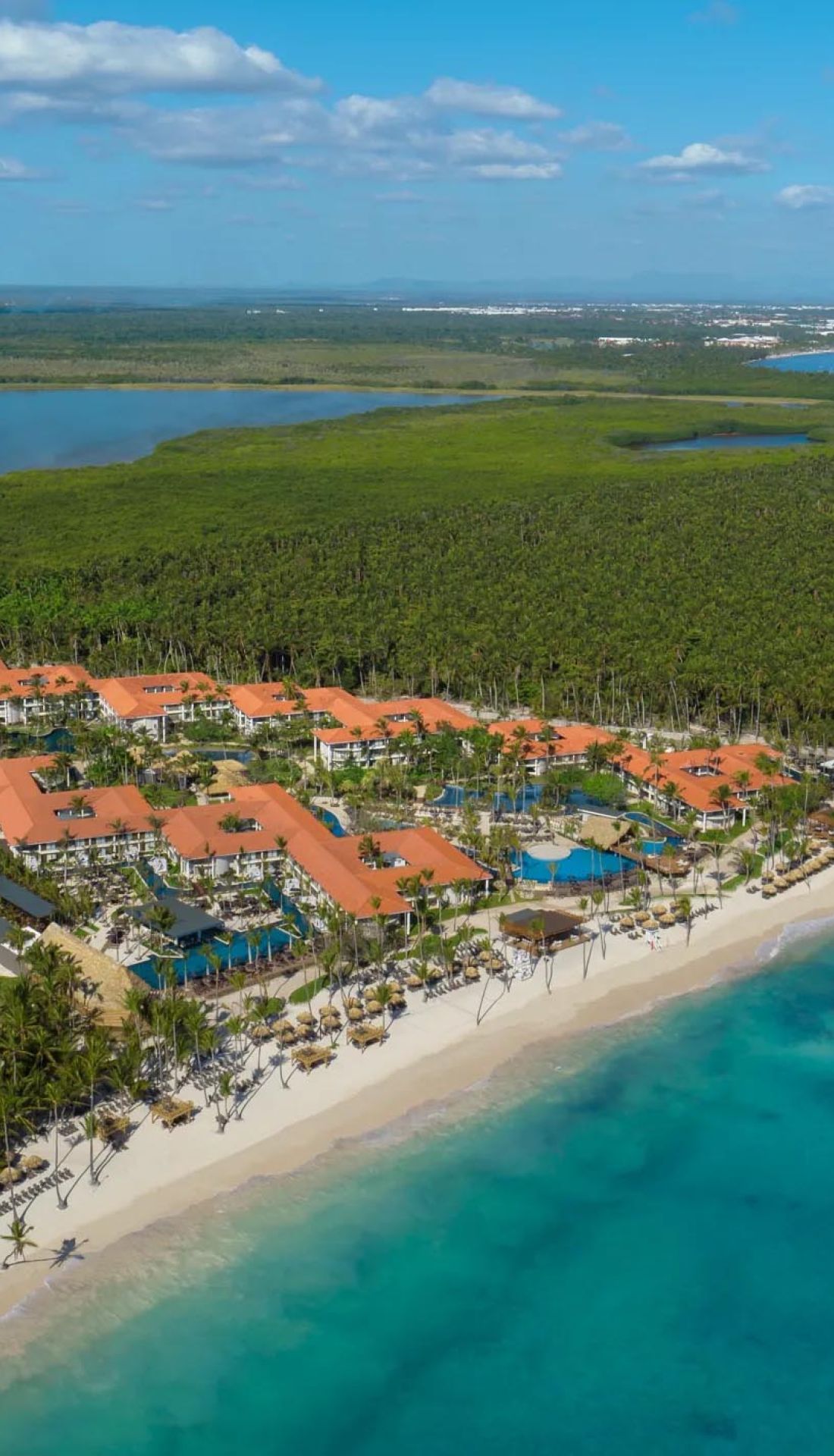Lush tropical gardens and infinity pool with ocean views at Dreams Flora Resort
